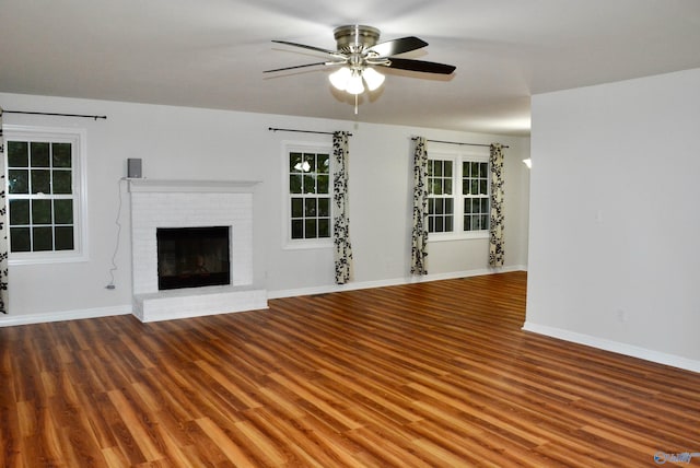 unfurnished living room with wood-type flooring, a fireplace, and ceiling fan