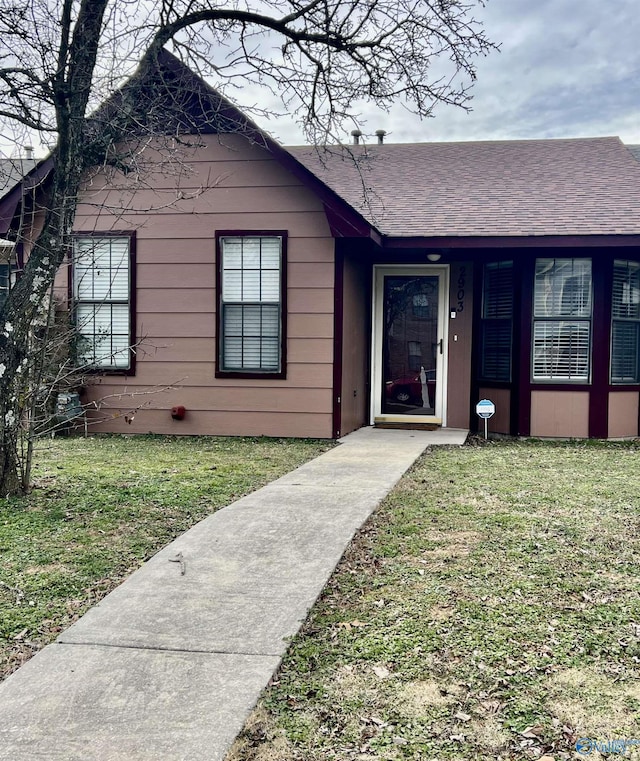 entrance to property featuring a yard