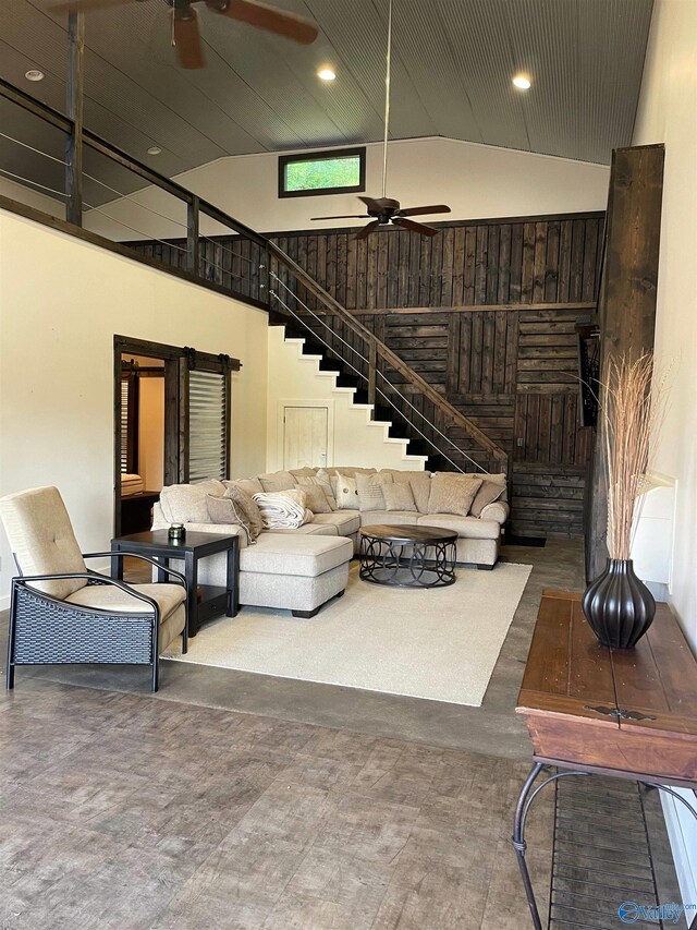 living room featuring ceiling fan and high vaulted ceiling