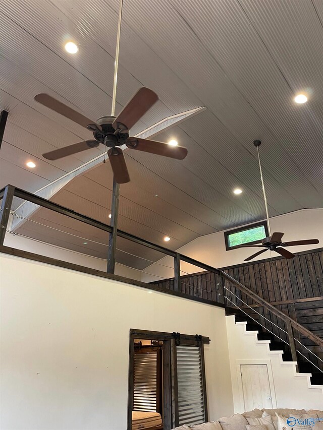 staircase with ceiling fan and a skylight