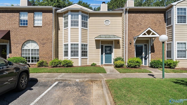 11112 Memorial Pkwy S Unit N3, Huntsville, AL 35803 - multi unit property with a chimney, brick siding, uncovered parking, and a front yard