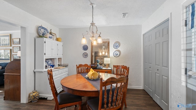 11112 Memorial Pkwy S Unit N3, Huntsville, AL 35803 - dining space featuring a textured ceiling, dark wood finished floors, a textured wall, a chandelier, and baseboards