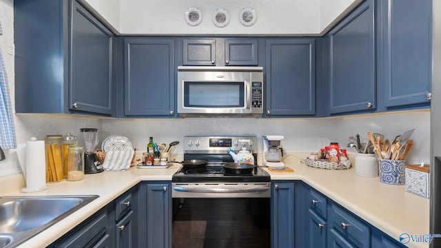11112 Memorial Pkwy S Unit N3, Huntsville, AL 35803 - kitchen featuring stainless steel appliances, blue cabinetry, and light countertops