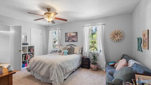 11112 Memorial Pkwy S Unit N3, Huntsville, AL 35803 - bedroom featuring light colored carpet, multiple windows, a textured ceiling, and ceiling fan