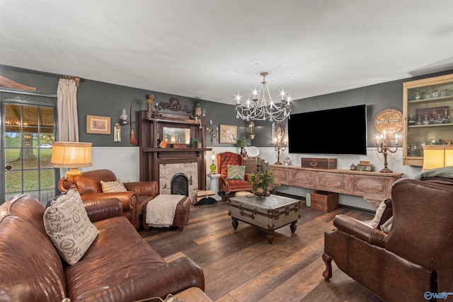 living room with a notable chandelier and hardwood / wood-style flooring