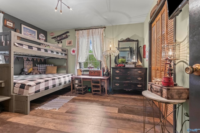 bedroom with hardwood / wood-style floors and a closet