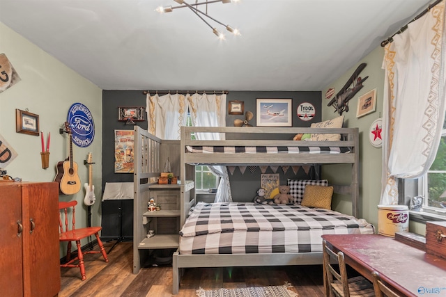 bedroom with multiple windows and hardwood / wood-style flooring