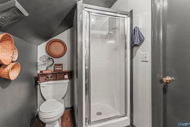 bathroom with walk in shower, hardwood / wood-style floors, and toilet