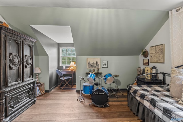 bedroom with lofted ceiling and hardwood / wood-style flooring