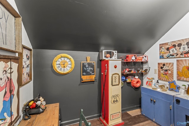 game room with sink, dark hardwood / wood-style floors, and vaulted ceiling