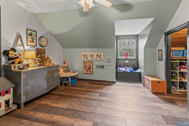 playroom with ceiling fan, lofted ceiling, and dark hardwood / wood-style flooring