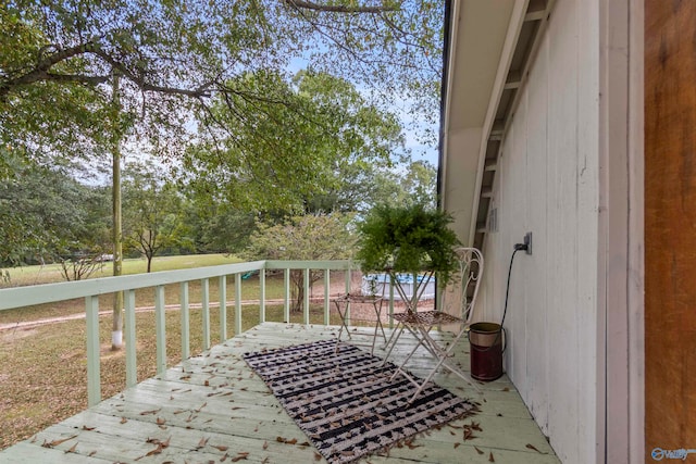 wooden terrace with a yard