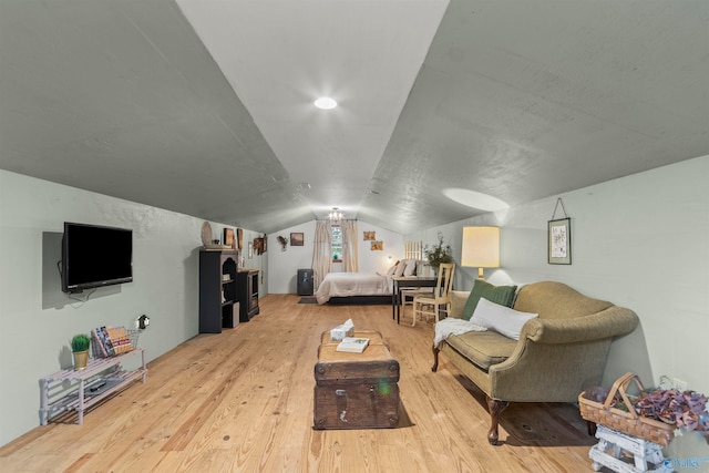 bedroom with light hardwood / wood-style flooring and vaulted ceiling