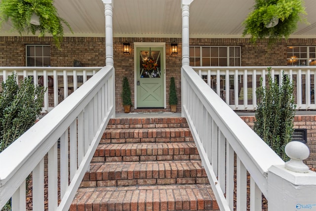 entrance to property featuring covered porch