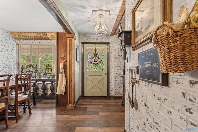 foyer with a notable chandelier and dark hardwood / wood-style floors