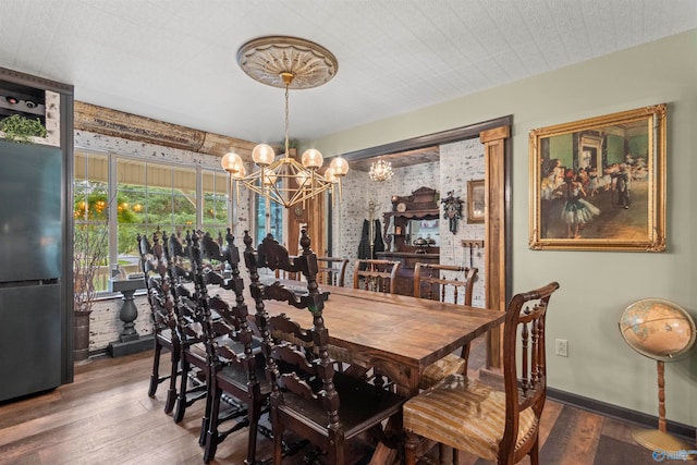 dining area featuring an inviting chandelier and dark hardwood / wood-style floors