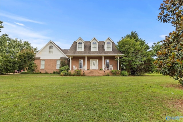 cape cod house with covered porch and a front lawn