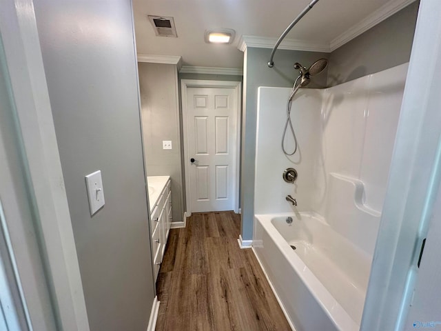 bathroom with vanity, crown molding, shower / tub combination, and hardwood / wood-style floors