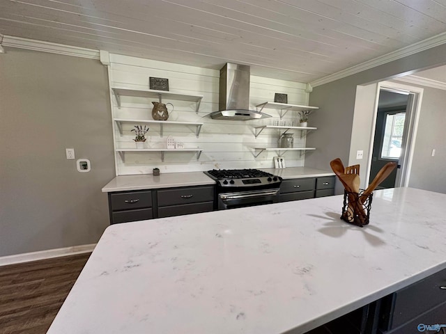 kitchen featuring island exhaust hood, light stone countertops, gas range, dark wood-type flooring, and crown molding