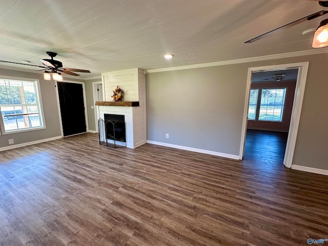 unfurnished living room featuring ceiling fan, a healthy amount of sunlight, ornamental molding, and dark hardwood / wood-style flooring