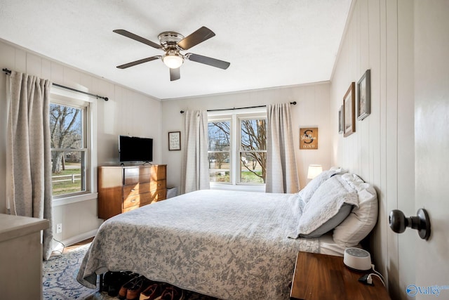 bedroom with multiple windows and ceiling fan