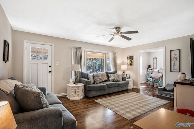 living room with dark hardwood / wood-style flooring and ceiling fan