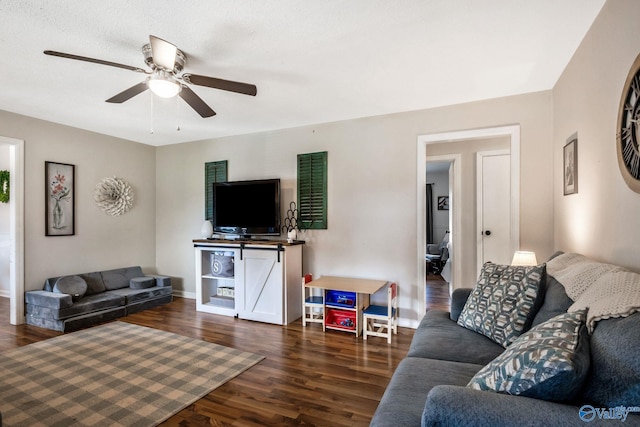 living room with ceiling fan and dark hardwood / wood-style flooring