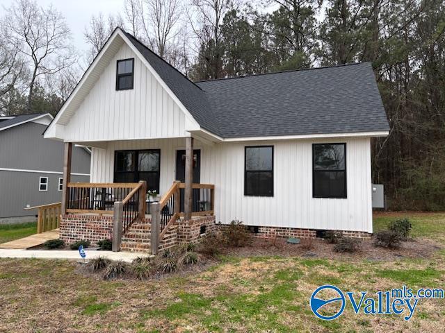 modern inspired farmhouse featuring a porch, crawl space, and a shingled roof