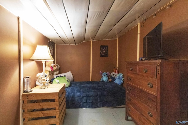 bedroom featuring light tile patterned floors and lofted ceiling