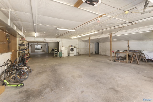 garage with washing machine and dryer and a garage door opener