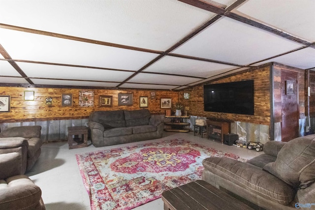 living area featuring wooden walls and concrete floors