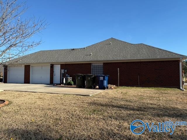 view of side of home featuring brick siding, roof with shingles, and an attached garage