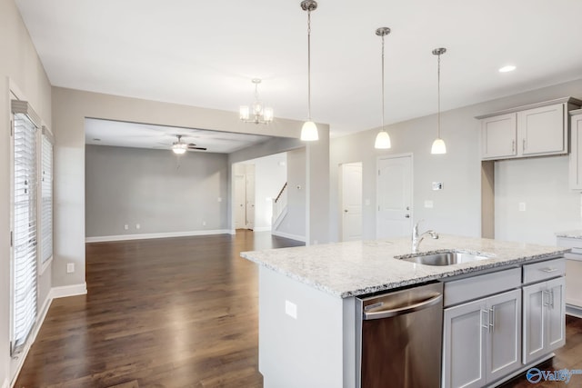 kitchen with stainless steel dishwasher, decorative light fixtures, light stone countertops, and ceiling fan with notable chandelier