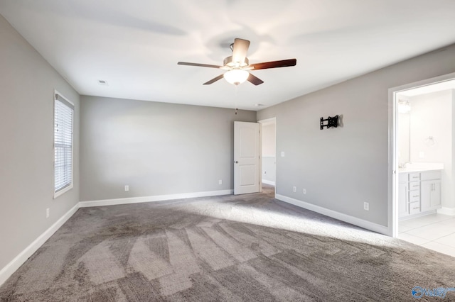 spare room featuring light colored carpet and ceiling fan