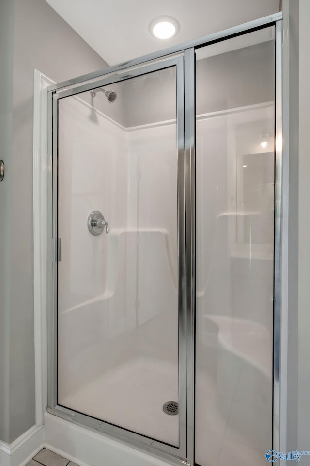 bathroom with a shower with shower door