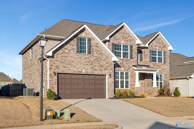 view of front of house featuring a garage and central AC unit