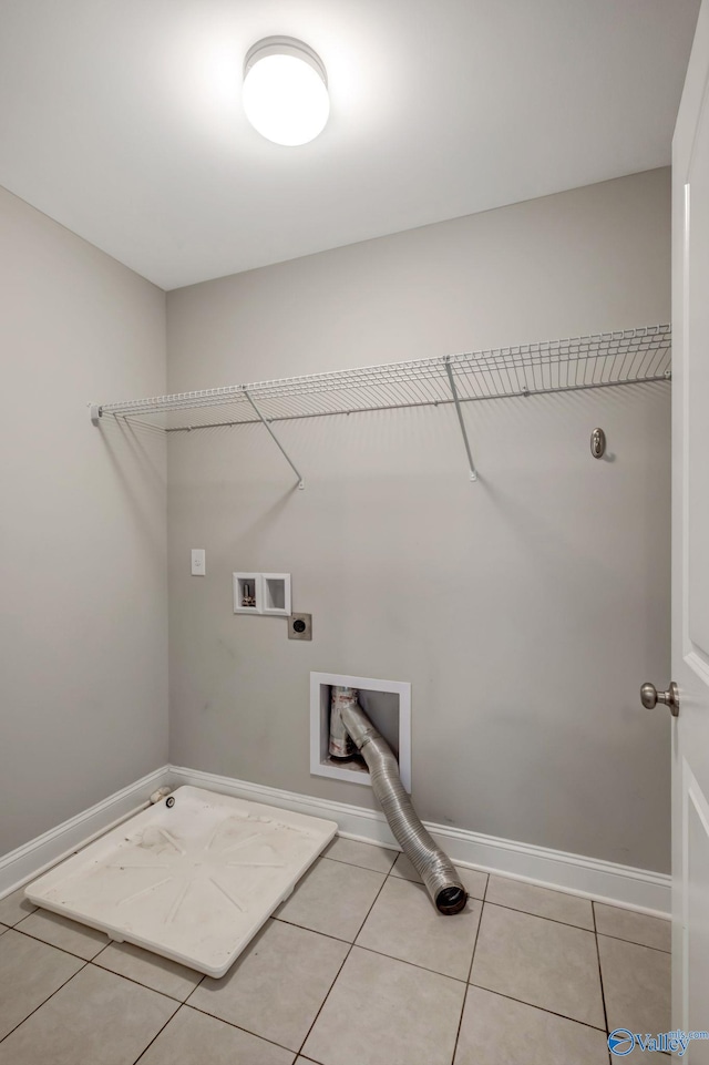 laundry area with electric dryer hookup, hookup for a gas dryer, light tile patterned flooring, and washer hookup