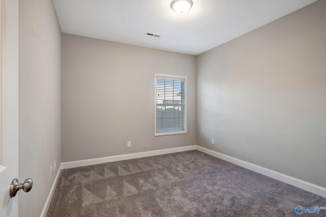 empty room with dark colored carpet