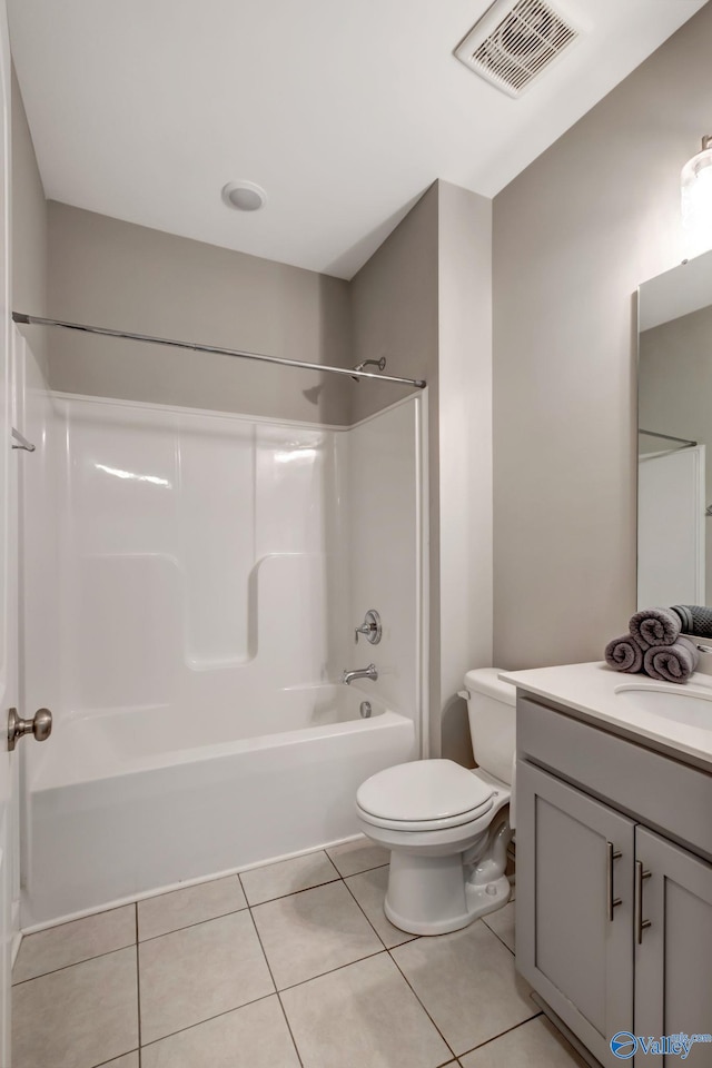 full bathroom featuring toilet, vanity, tile patterned floors, and shower / bathtub combination