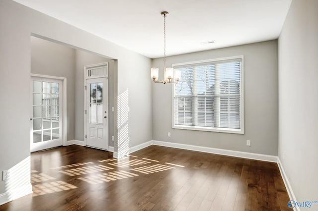 interior space with dark hardwood / wood-style flooring and an inviting chandelier