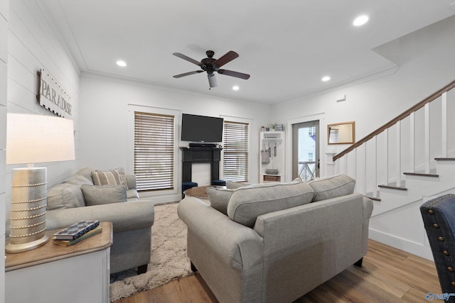 living room with ceiling fan, hardwood / wood-style floors, and crown molding