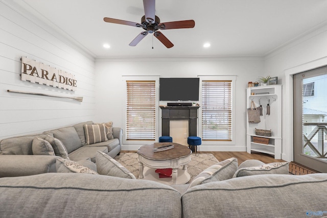 living room with plenty of natural light, ornamental molding, and hardwood / wood-style flooring