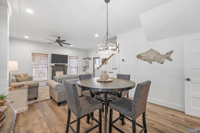 dining space featuring light hardwood / wood-style floors, ceiling fan, and crown molding