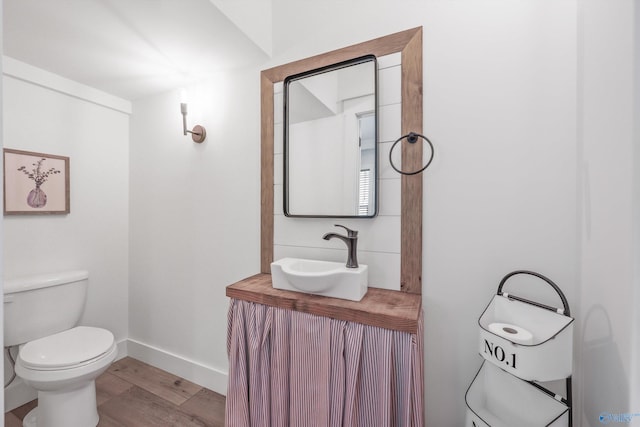 bathroom featuring hardwood / wood-style floors, vanity, and toilet