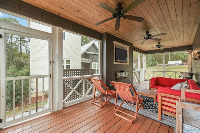 sunroom / solarium with a wealth of natural light, a large fireplace, and wood ceiling