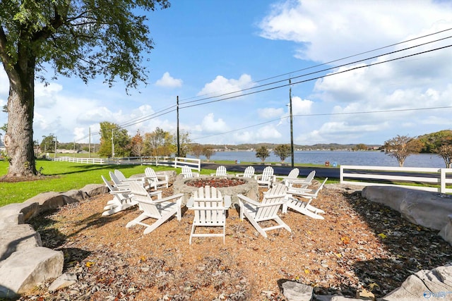 view of yard with a fire pit and a water view