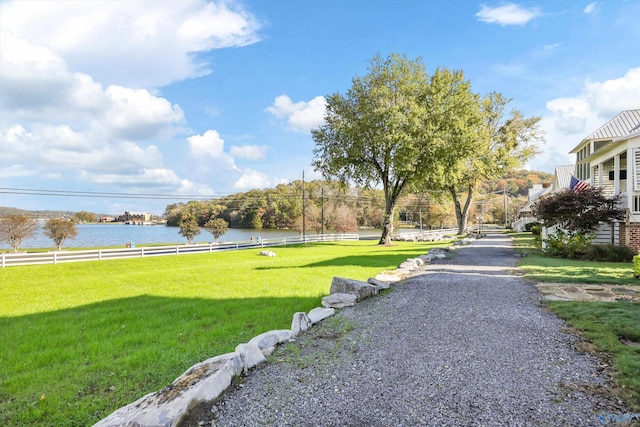 view of community with a water view and a lawn