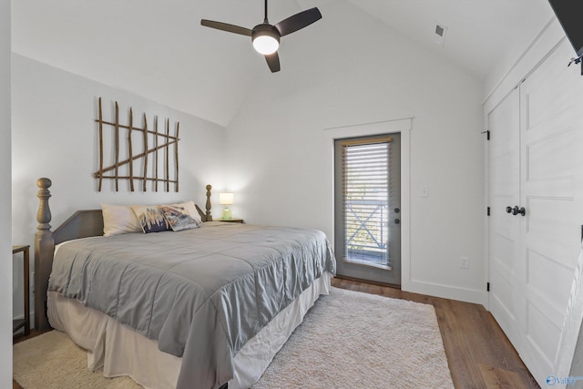 bedroom featuring hardwood / wood-style floors, ceiling fan, access to outside, and vaulted ceiling