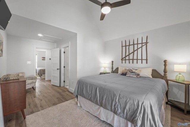 bedroom with hardwood / wood-style floors, ceiling fan, and lofted ceiling