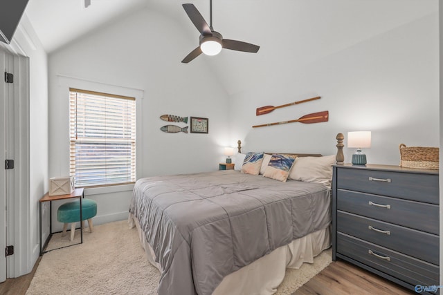 bedroom featuring light wood-type flooring, ceiling fan, and lofted ceiling